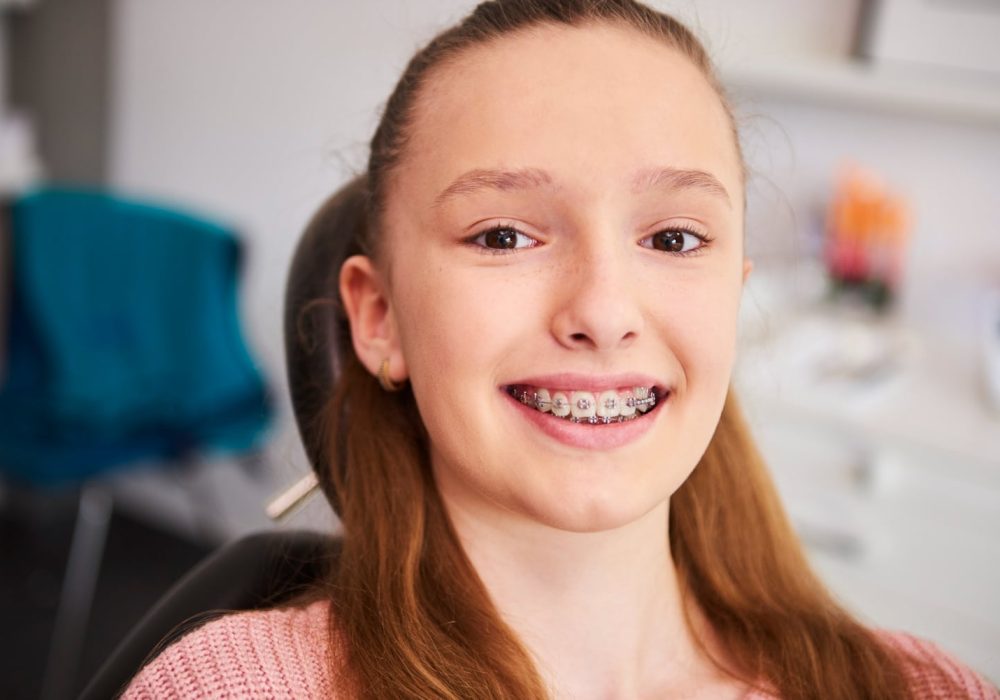 portrait-smiling-child-with-braces-dentist-s-office